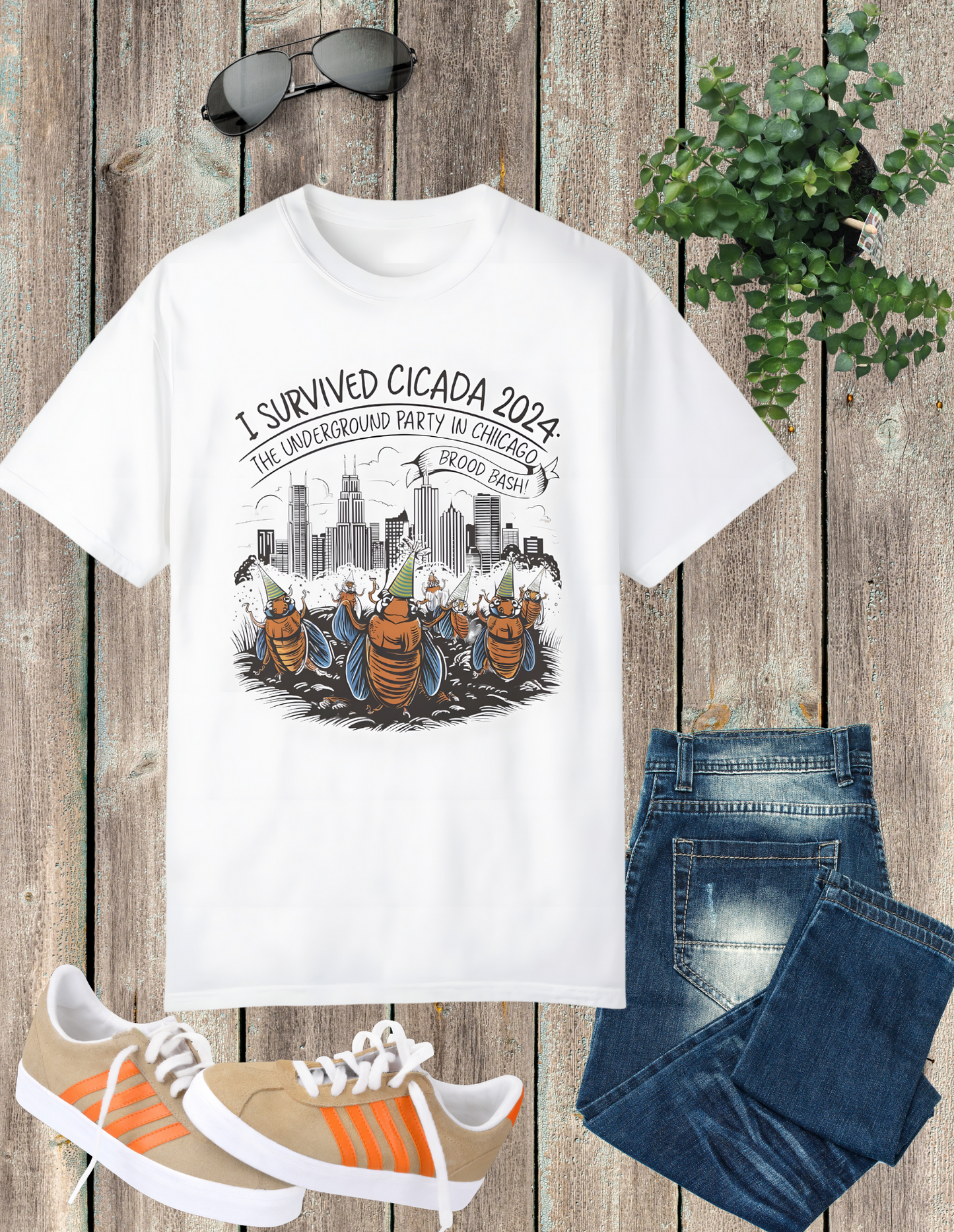 White t-shirt with a graphic of cicadas in front of a cityscape, captioned 'I Survived Cicada 2024, The Underground Party in the city.