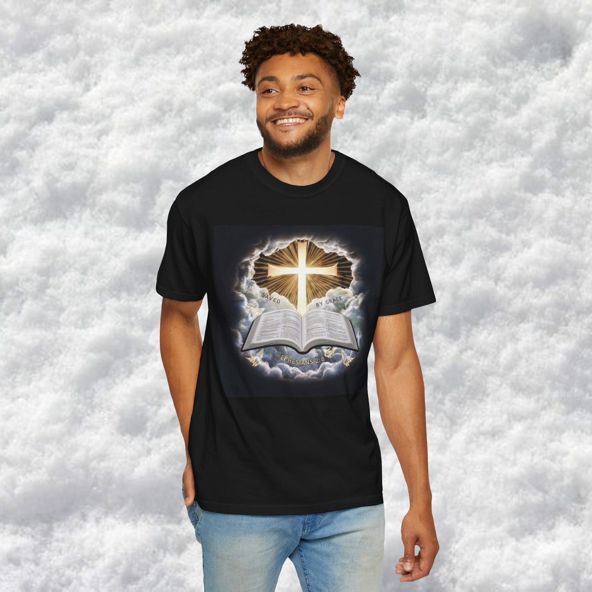 Divine "Saved by Grace" Christian graphic tee featuring a radiant cross emerging from the clouds and an open Bible with Ephesians 2:8, perfect for expressing faith and spirituality.