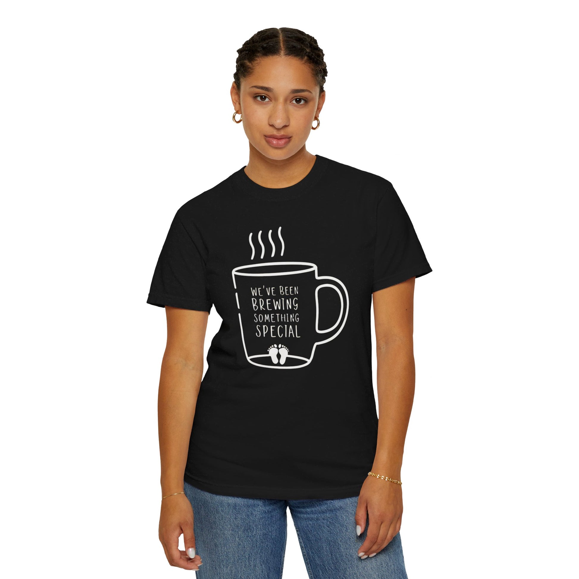 Black t-shirt featuring a coffee mug graphic with the text "We've Been Brewing Something Special" and tiny baby footprints.