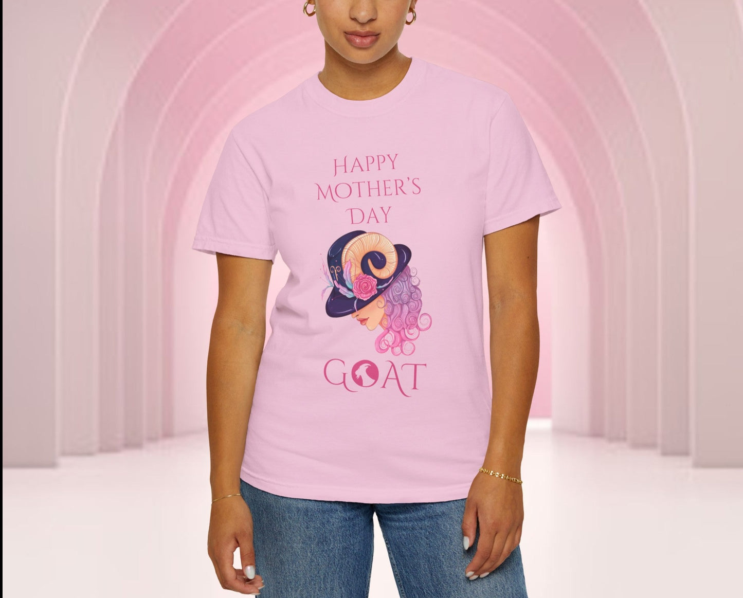 Mother's Day 'GOAT' tee in pastel hues, featuring playful 'Greatest Of All Time' typography intertwined with a whimsical illustration, perfect for celebrating Mom's endless love and strength.