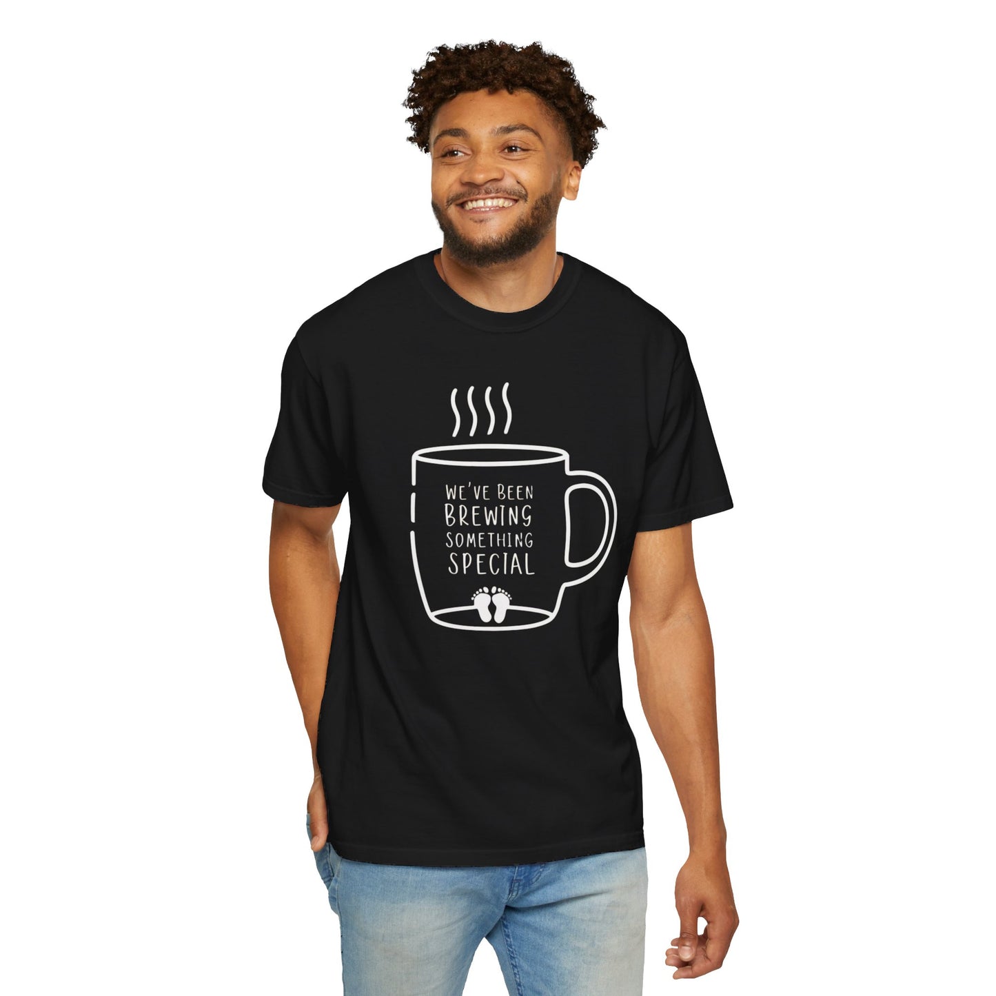 Black t-shirt featuring a coffee mug graphic with the text "We've Been Brewing Something Special" and tiny baby footprints.