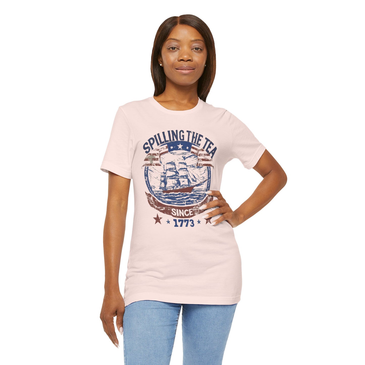 Various t-shirts featuring the text "Spilling the Tea Since 1773" with vintage-inspired graphics of ships and patriotic elements.