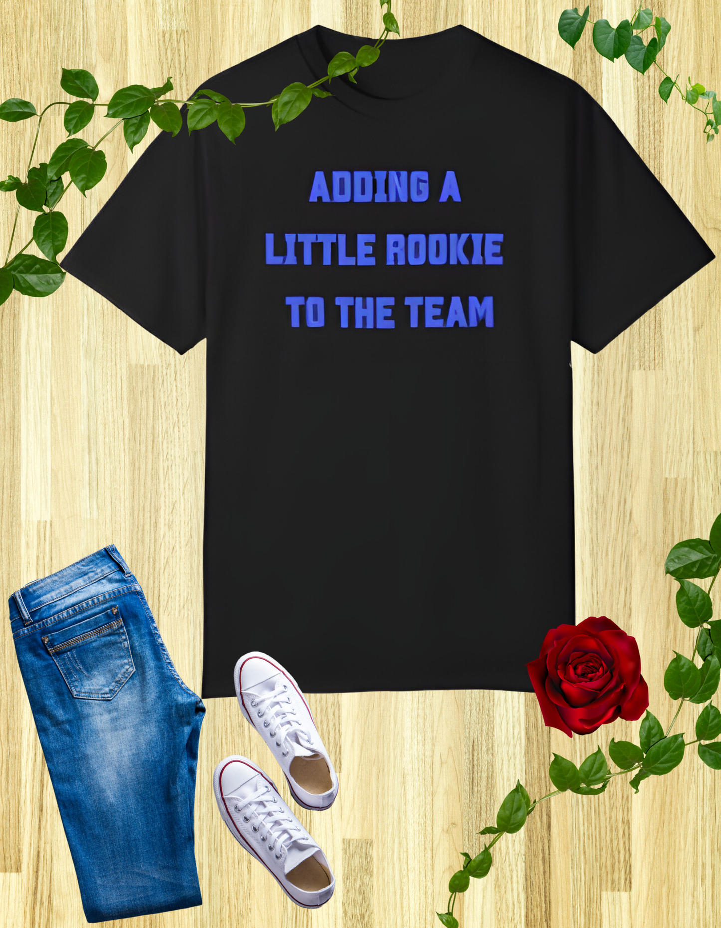 Black t-shirt with the text "Adding a Little Rookie to the Team" in a bold and playful font, available in blue, pink, and white.