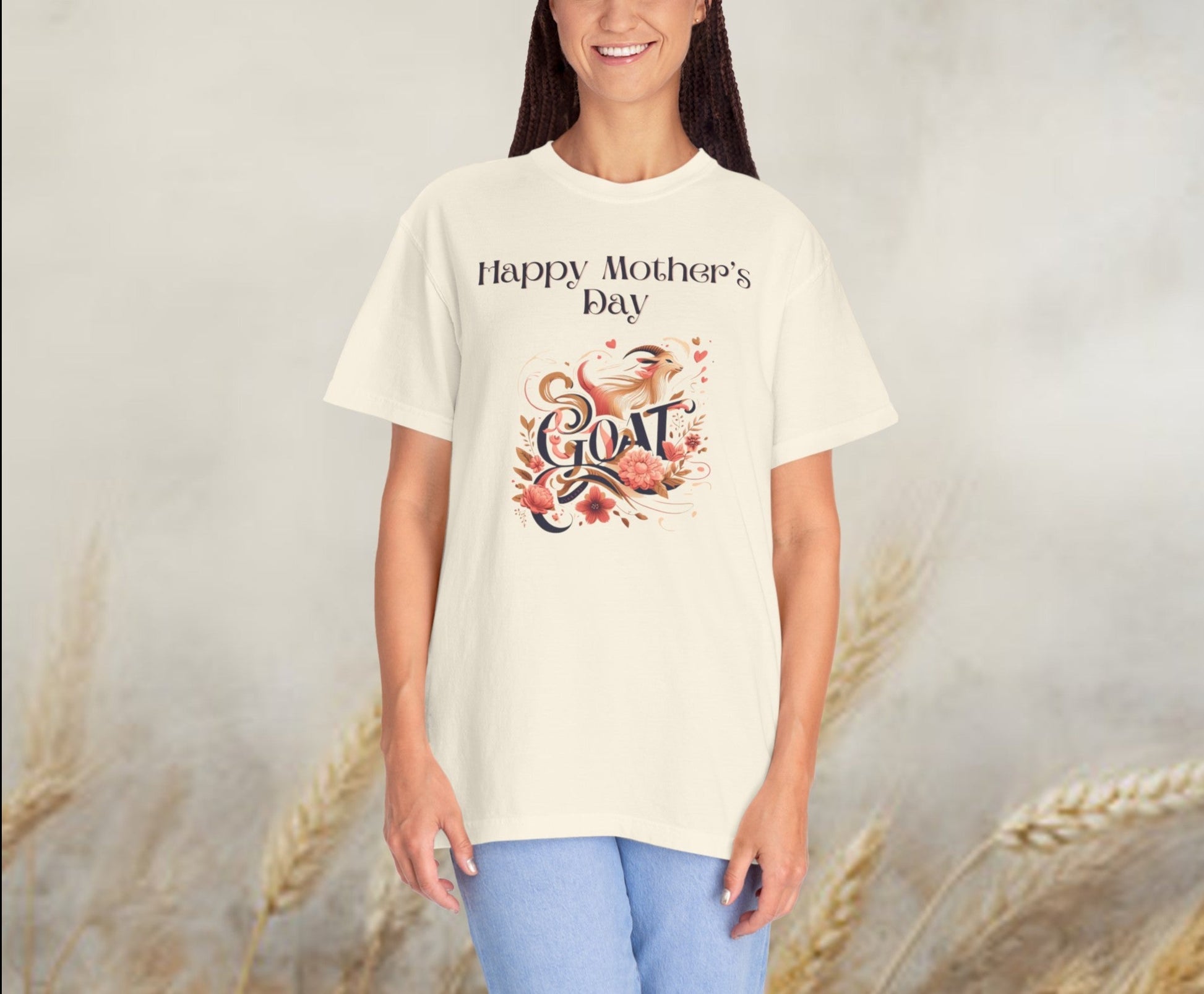 Mother's Day 'GOAT' tee in pastel hues, featuring playful 'Greatest Of All Time' typography intertwined with a whimsical illustration, perfect for celebrating Mom's endless love and strength.