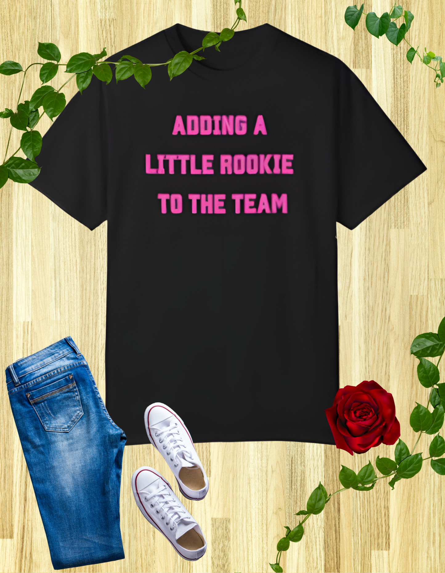 Black t-shirt with the text "Adding a Little Rookie to the Team" in a bold and playful font, available in blue, pink, and white.