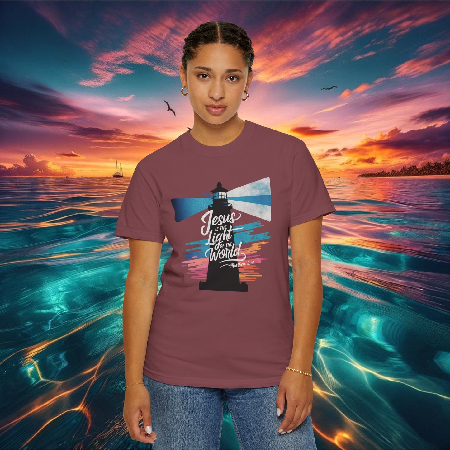 Inspirational "Jesus is the Light of the World" Christian graphic tee featuring a vibrant lighthouse design with colorful beams and a message from Matthew 5:14, perfect for expressing faith and spirituality with a vintage touch.