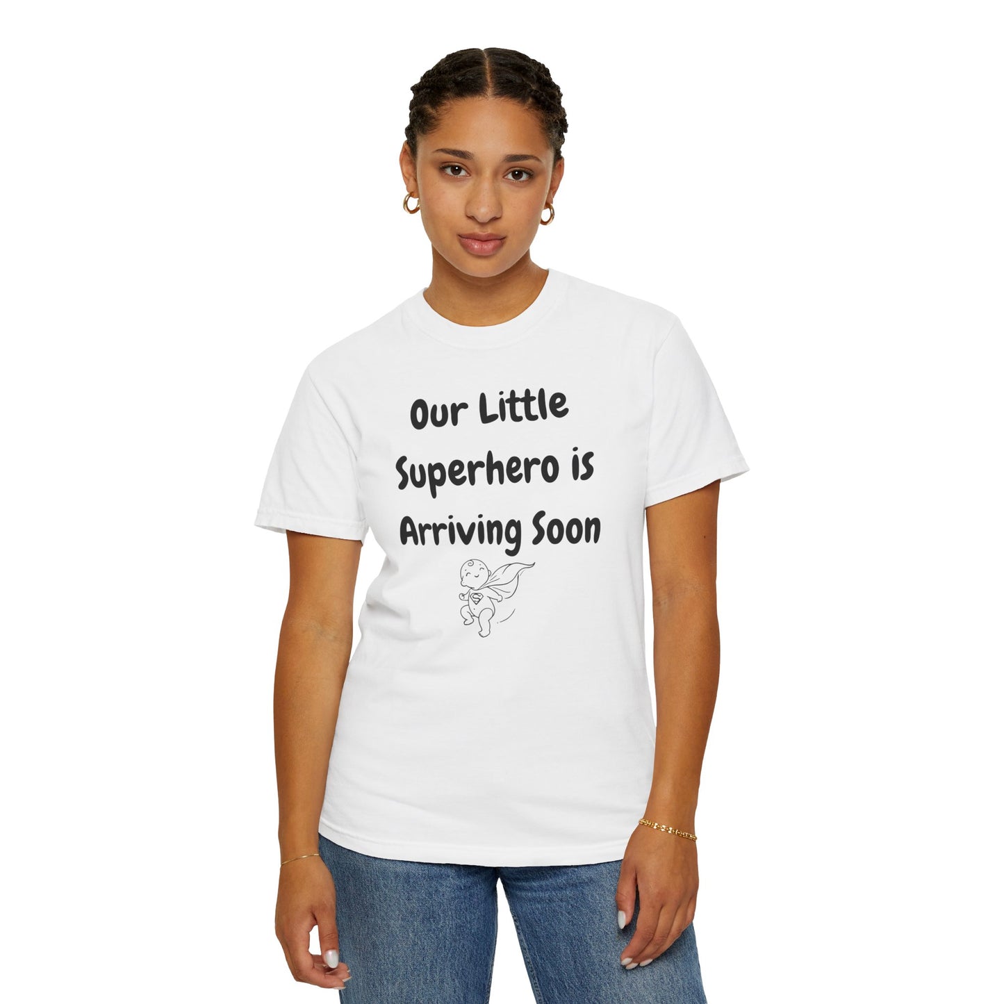 White t-shirt featuring the text "Our Little Superhero is Arriving Soon" with a cute superhero graphic.