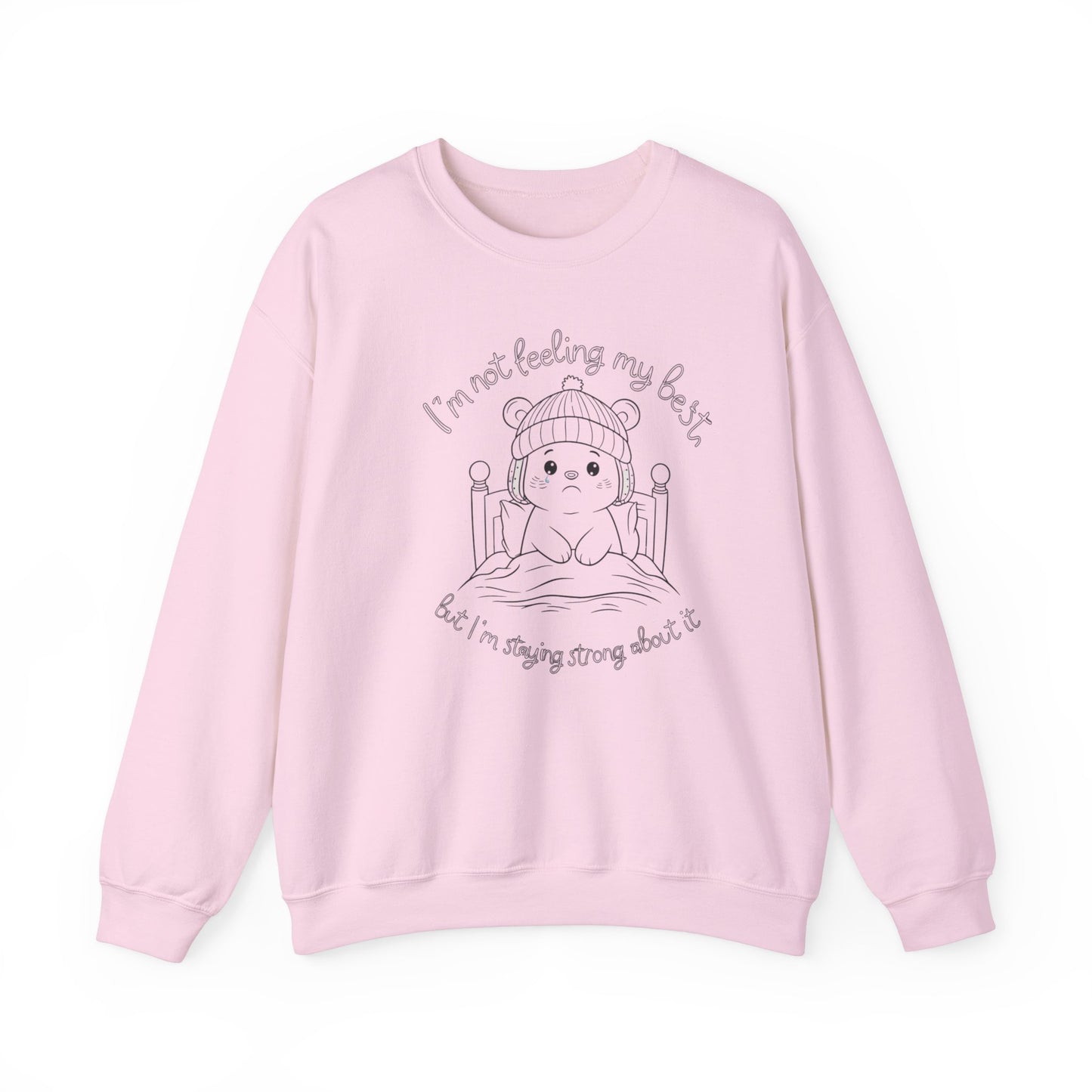 Adorable pink sweatshirt with a line-art illustration of a bear in bed, with text 'I'm not feeling my best' and 'but I'm staying strong about it.'