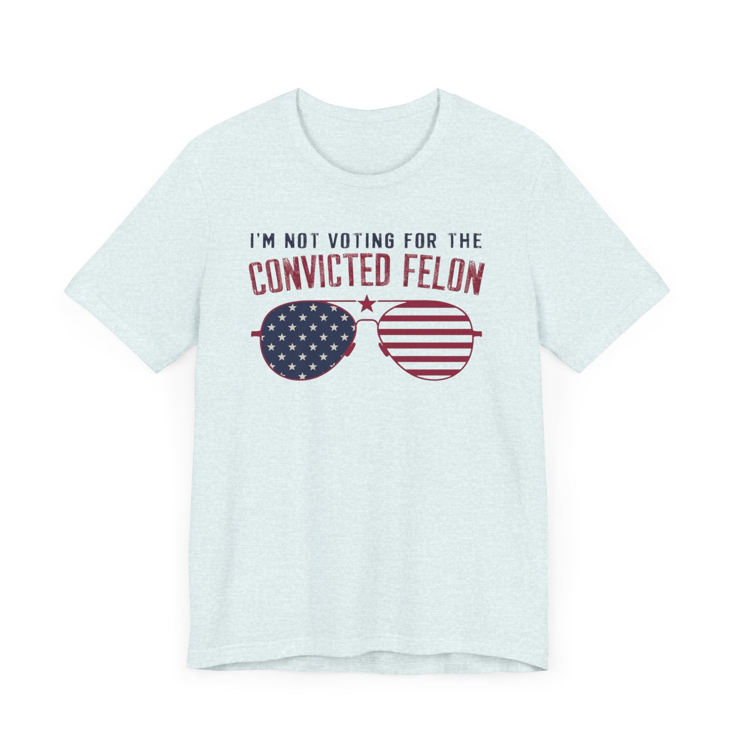 White t-shirts featuring the text "I'm Not Voting for the Convicted Felon" with a patriotic design of American flag sunglasses.