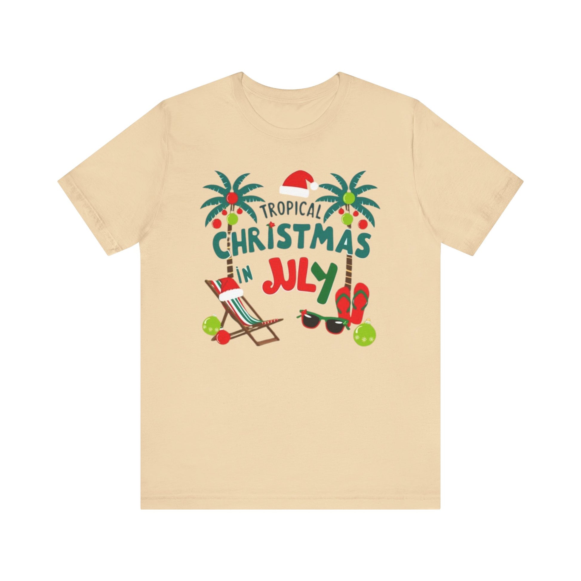 Tropical-themed t-shirts featuring the text "Christmas in July" with festive elements like palm trees, beach chairs, and a Santa.