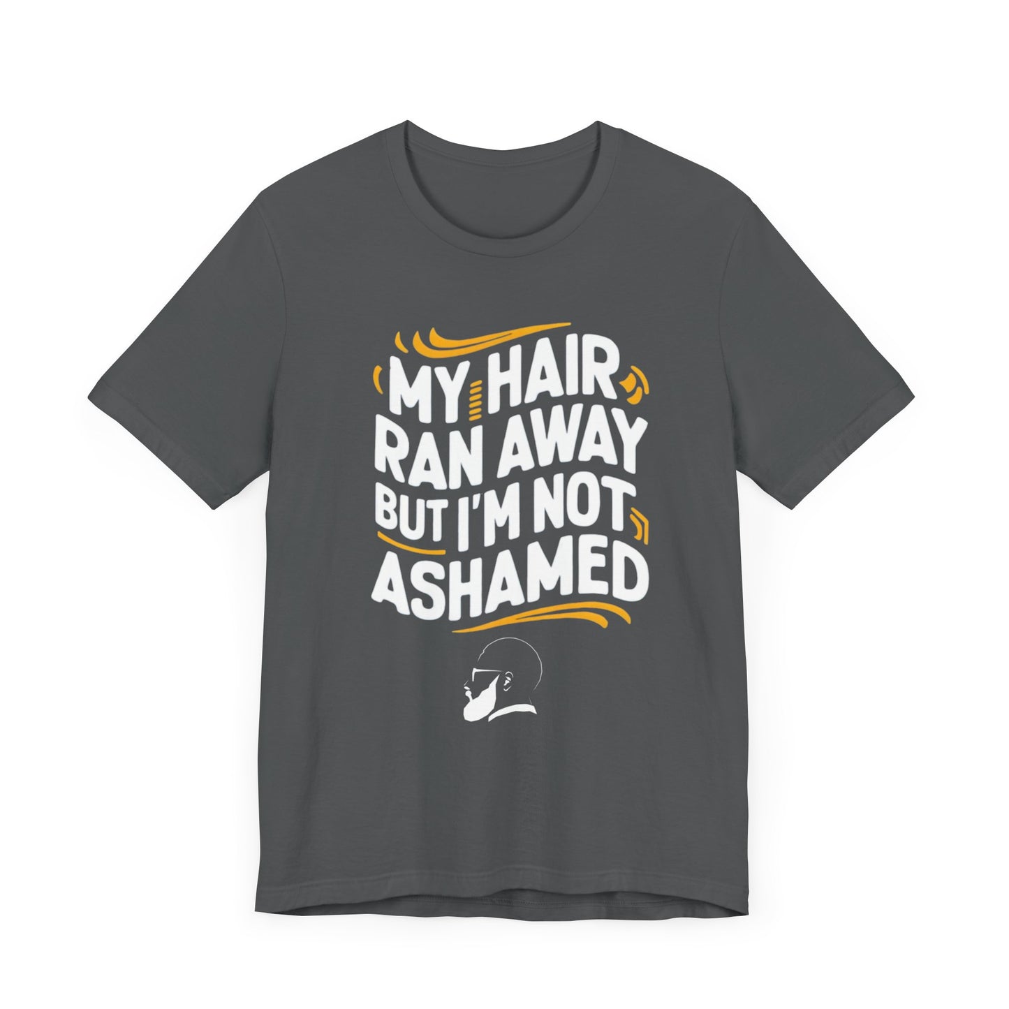 A  t-shirt with the text "My Hair Ran Away But I'm Not Ashamed" in bold white and yellow letters, accompanied by a playful illustration of a bald head with a smile.