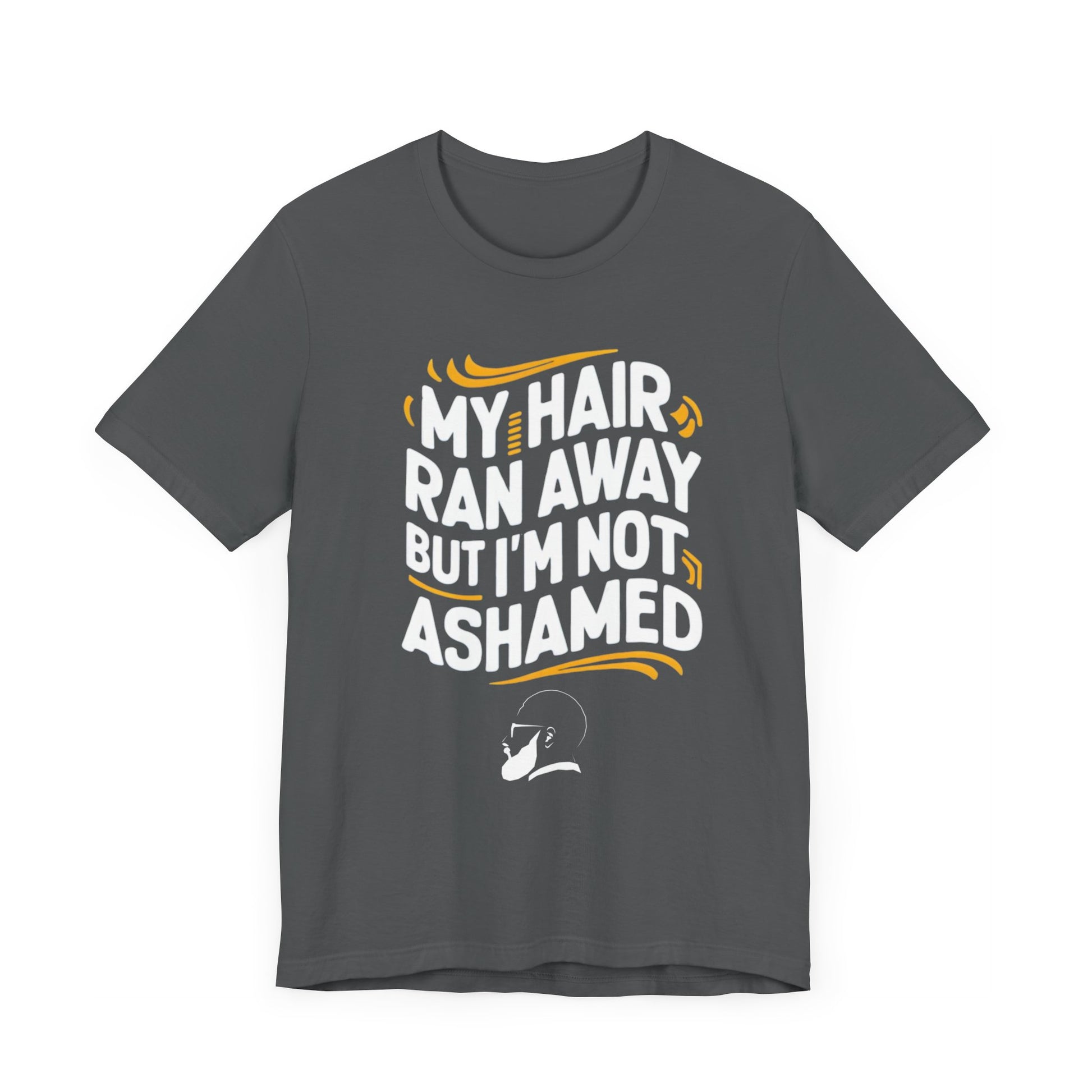 A  t-shirt with the text "My Hair Ran Away But I'm Not Ashamed" in bold white and yellow letters, accompanied by a playful illustration of a bald head with a smile.