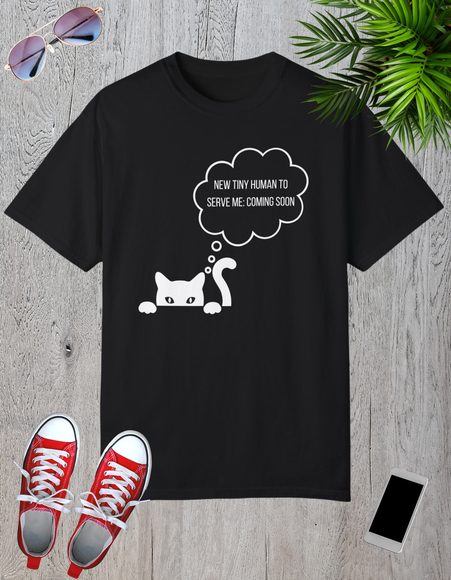 Black t-shirt featuring a playful cat graphic with the text "New Tiny Human to Serve Me, Coming Soon" in a thought bubble.