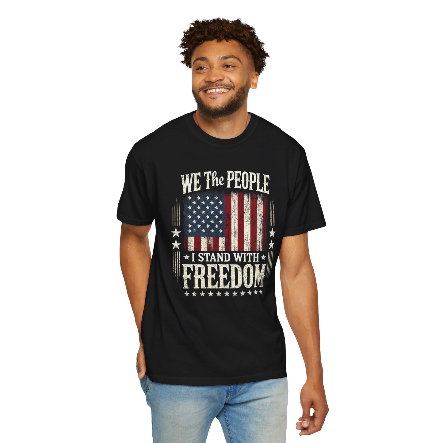 A black t-shirt featuring the text 'We The People - I Stand With Freedom' with a vintage American flag graphic.