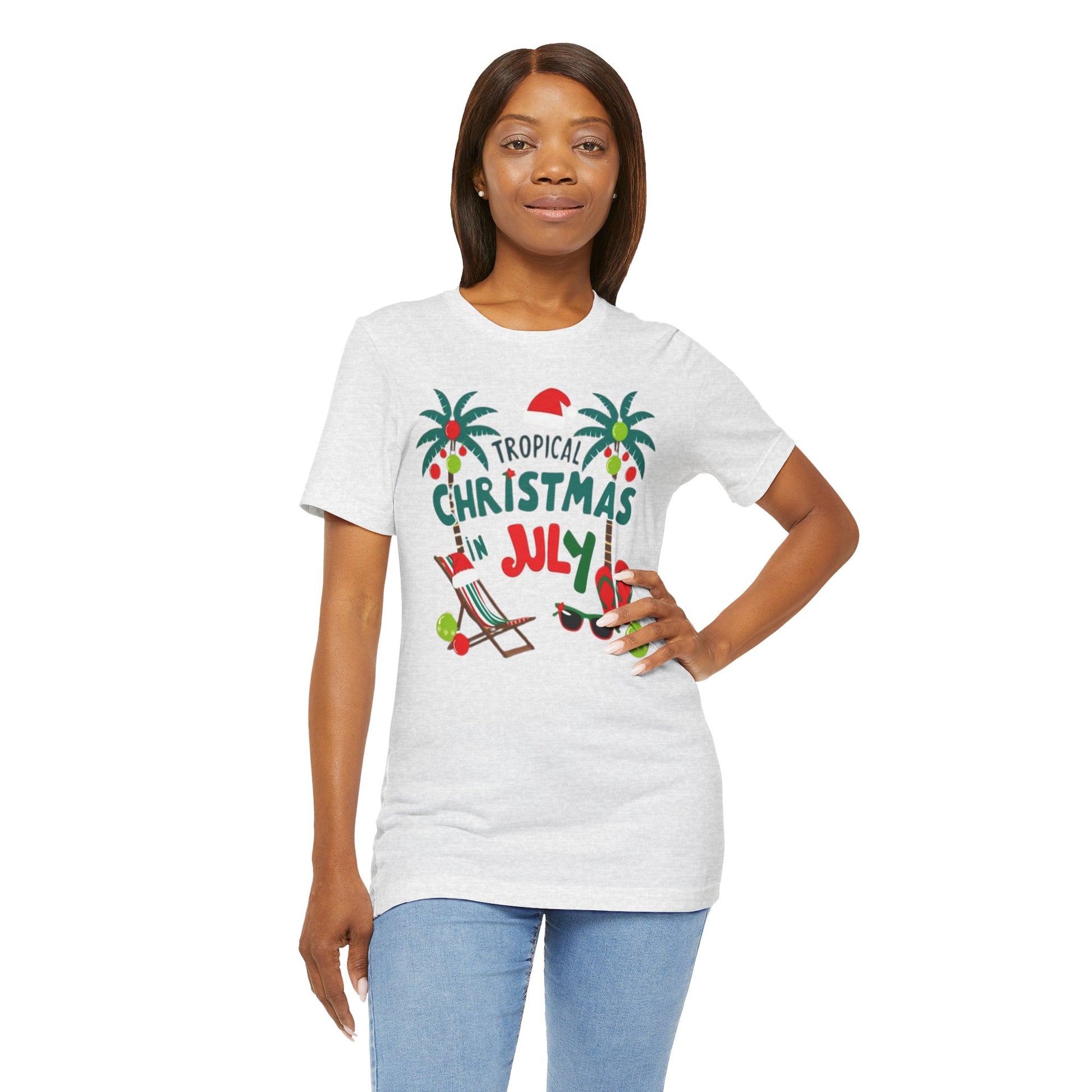 Tropical-themed t-shirts featuring the text "Christmas in July" with festive elements like palm trees, beach chairs, and a Santa.