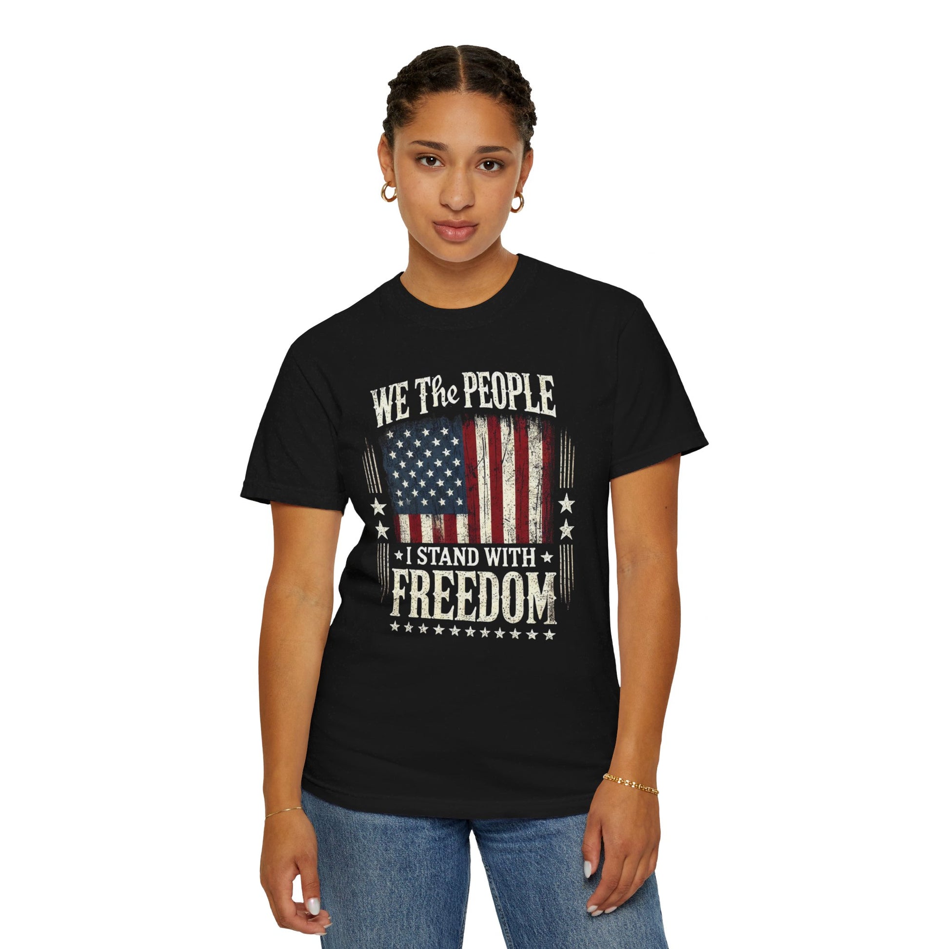 A black t-shirt featuring the text 'We The People - I Stand With Freedom' with a vintage American flag graphic.