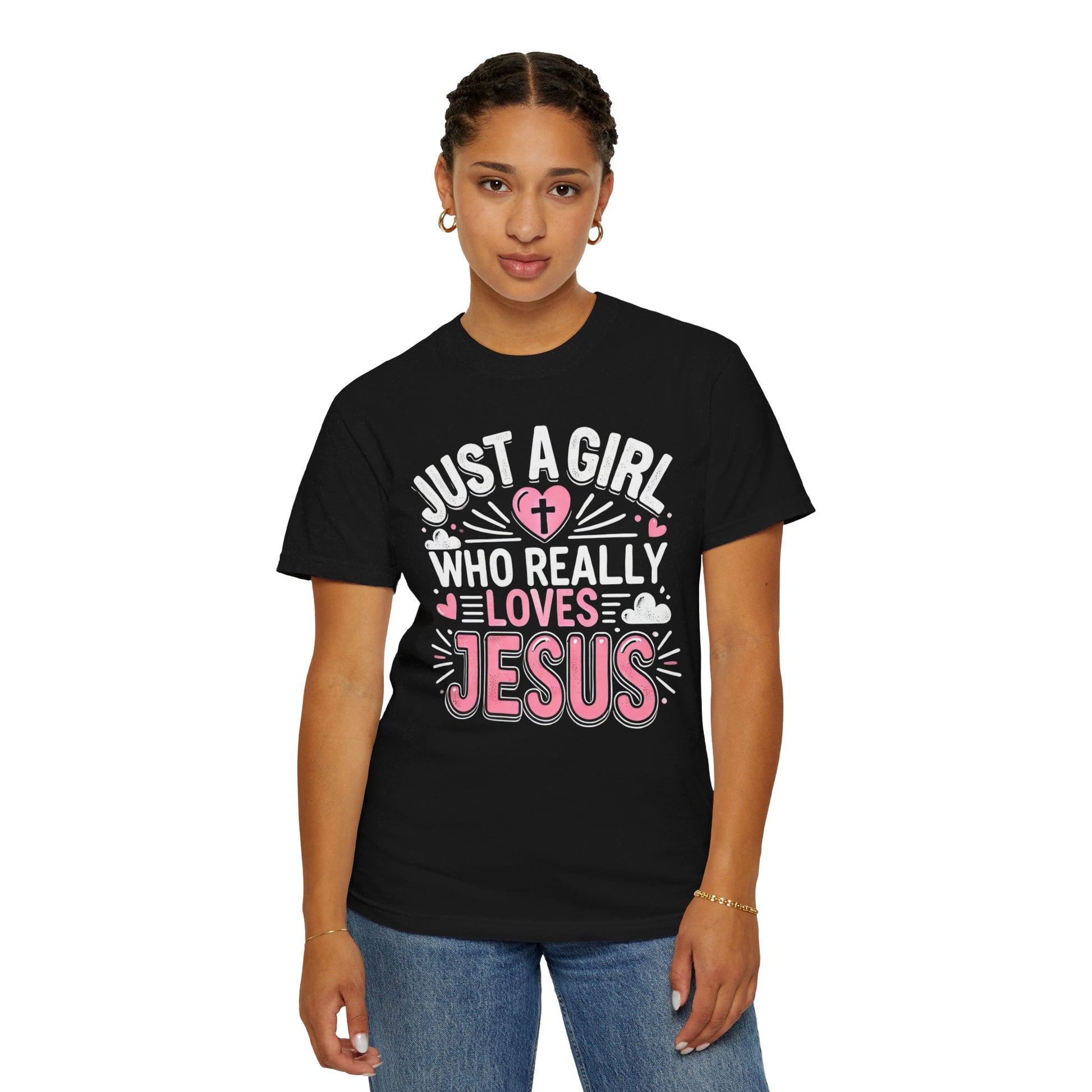 A black t-shirt with the text 'Just a Girl Who Really Loves Jesus' in bold, white and pink lettering, featuring a heart with a cross and small heart decorations.