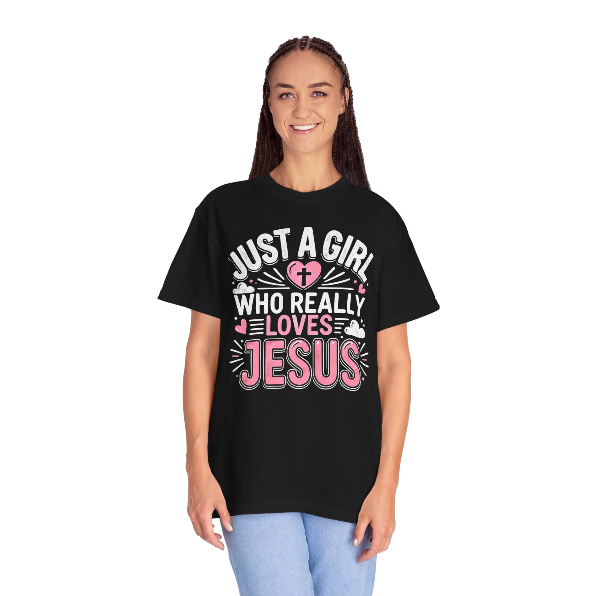 A black t-shirt with the text 'Just a Girl Who Really Loves Jesus' in bold, white and pink lettering, featuring a heart with a cross and small heart decorations.