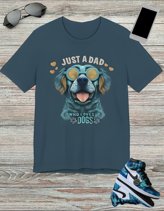 T-shirt featuring a vibrant and colorful graphic of a dog wearing glasses, with the text "Just a Dad Who Loves Dogs" prominently displayed. Perfect for dog dads and Father's Day gifts.