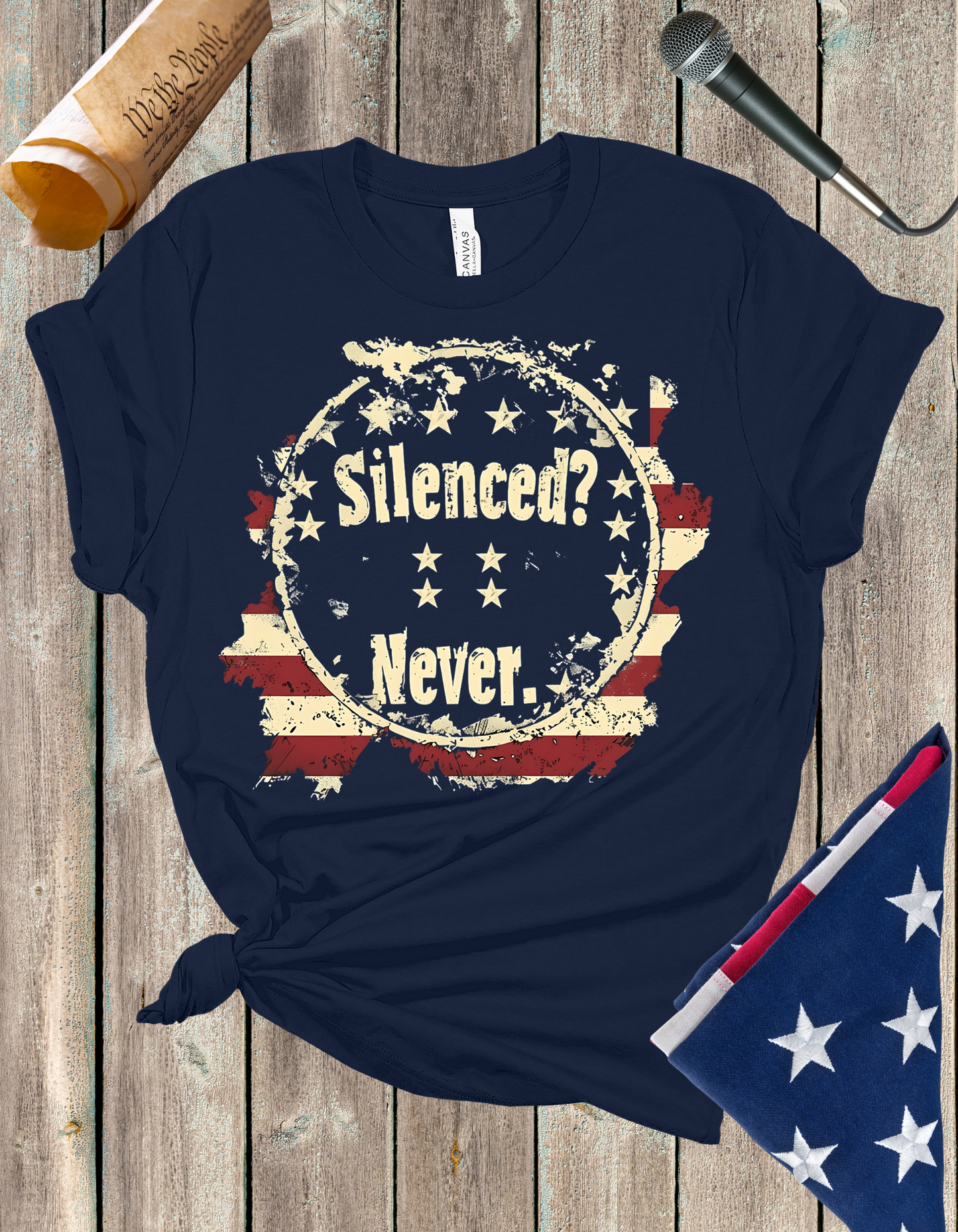 Silenced? Never. t-shirt with a distressed American flag background, featuring bold white text