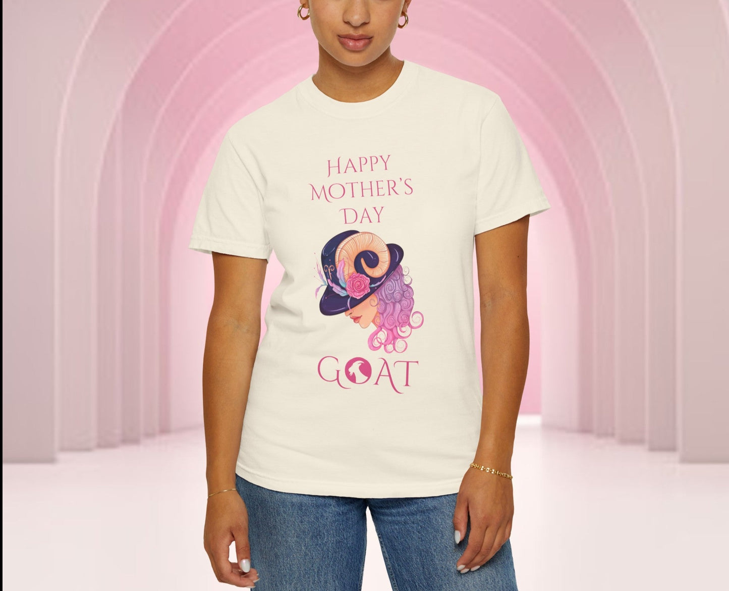 Mother's Day 'GOAT' tee in pastel hues, featuring playful 'Greatest Of All Time' typography intertwined with a whimsical illustration, perfect for celebrating Mom's endless love and strength.