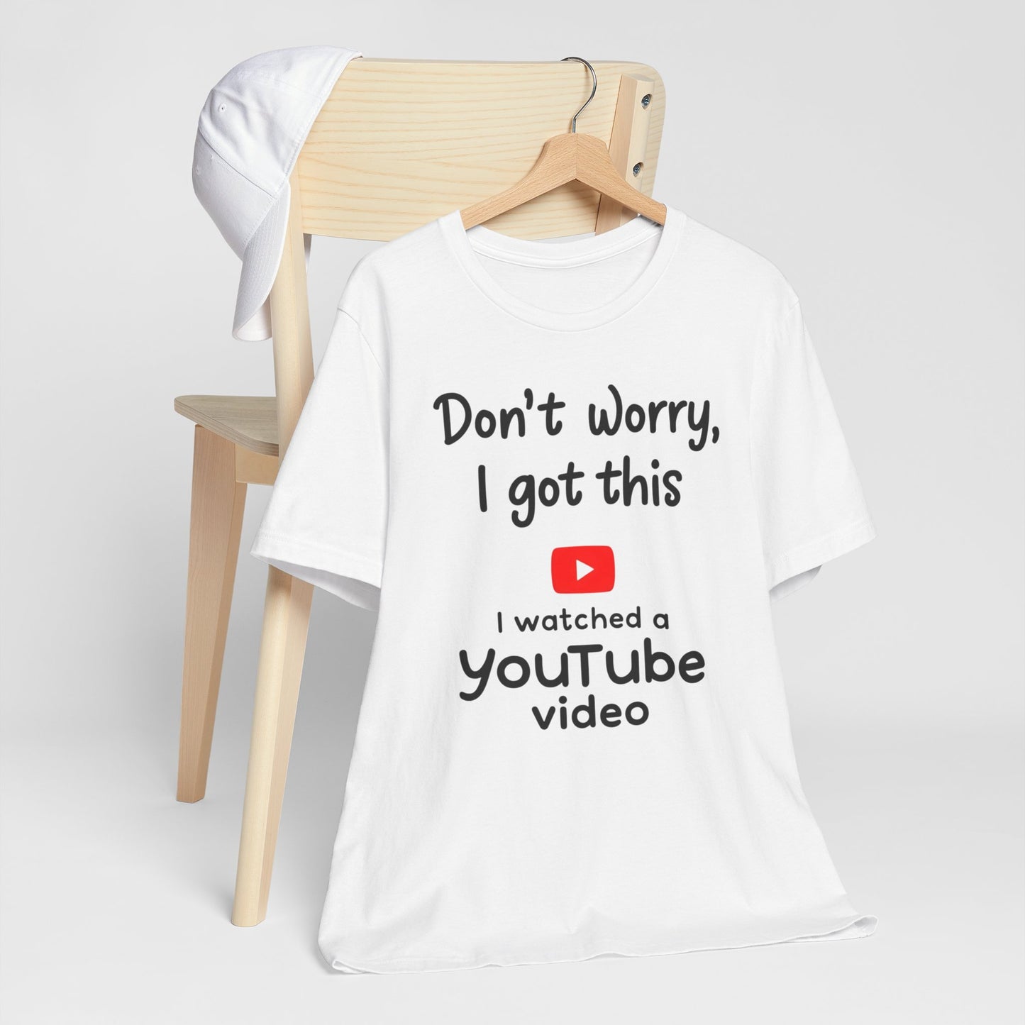 Black and white t-shirts featuring the text "Don't Worry, I Got This - I Watched a YouTube Video" with a playful YouTube logo graphic.